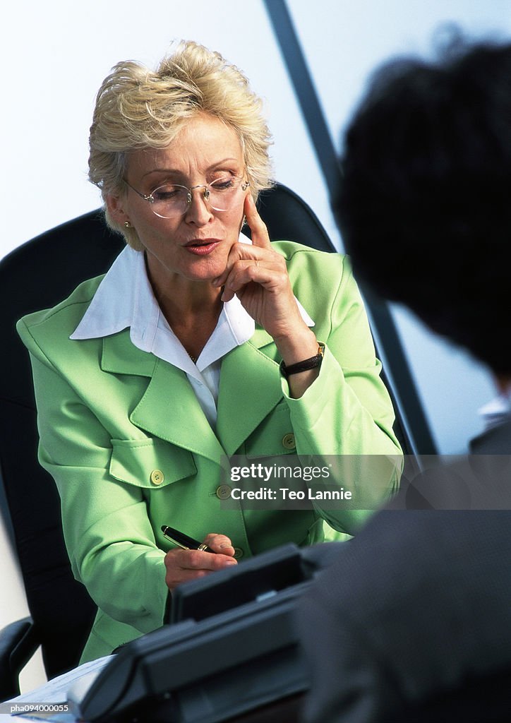 Businesswoman writing, blurred foreground