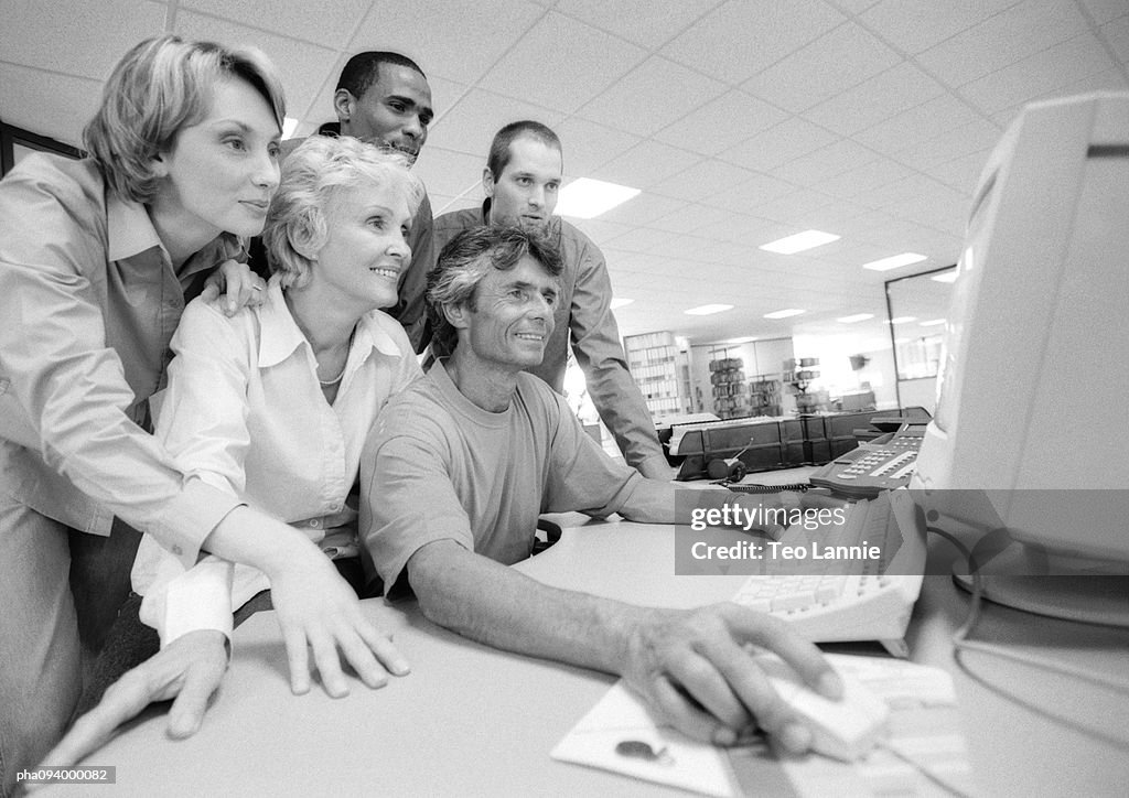 Group of business people looking at computer, B&W