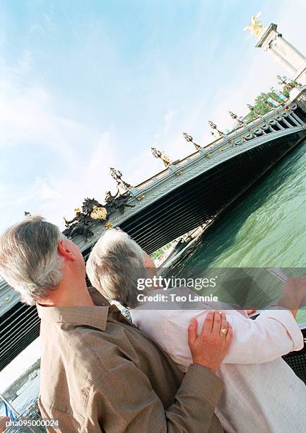 mature woman and man looking at a bridge - travel11 stock pictures, royalty-free photos & images