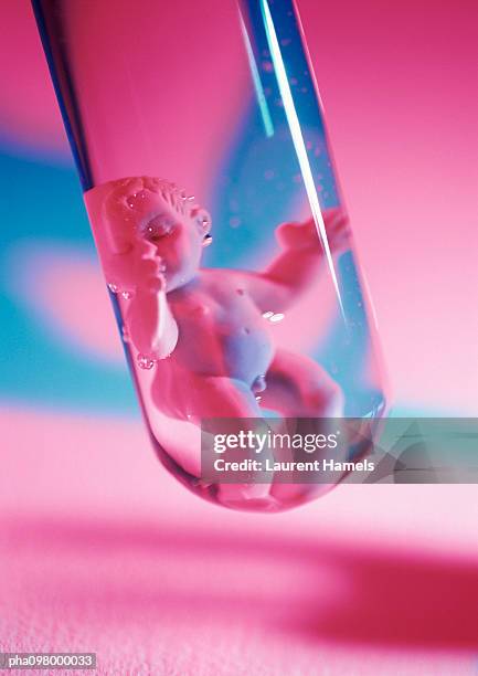 plastic baby doll in test tube, close-up - baby doll fotografías e imágenes de stock