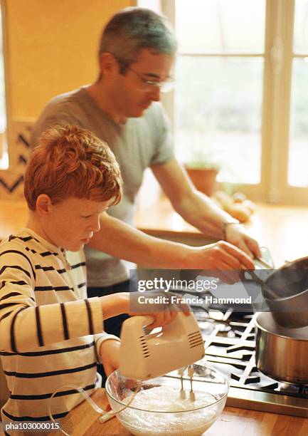 child beating  egg whites, man holding saucepan - egg ストックフォトと画像