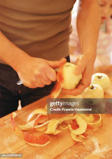 hands peeling apples - éplucher photos et images de collection