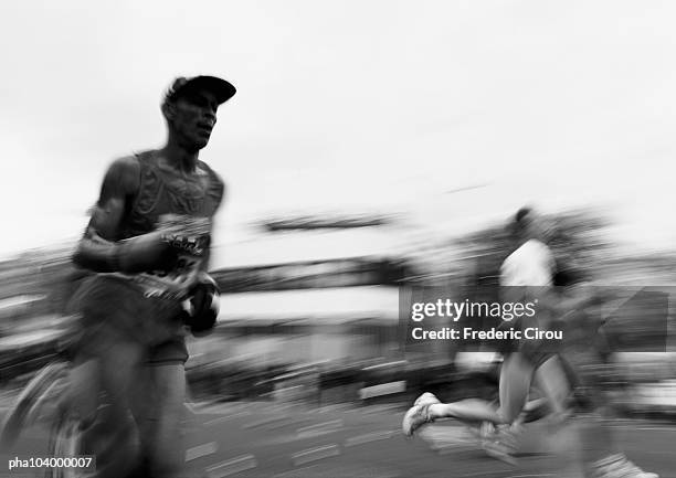 people jogging outside, blurred motion, b&w - schwenk stock-fotos und bilder