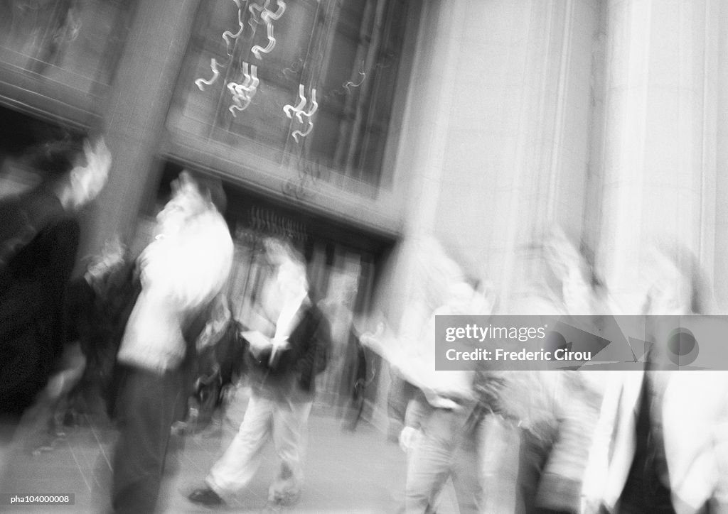 People in city sidewalk, blurred, b&w