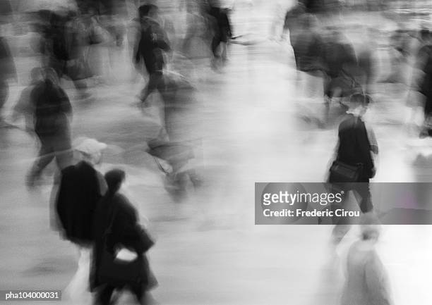 people walking in street, blurred, b&w - 通過する ストックフォトと画像