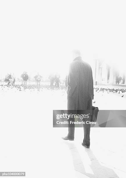 man holding briefcase, blurred, b&w - birds b w stock pictures, royalty-free photos & images