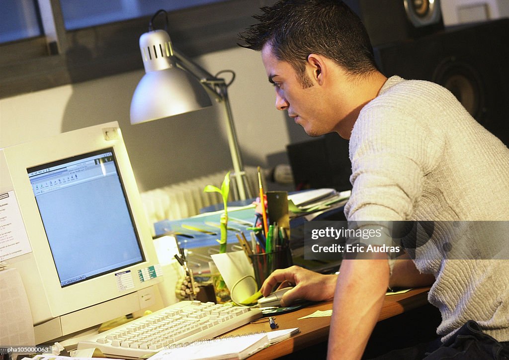 Man working on computer, side view