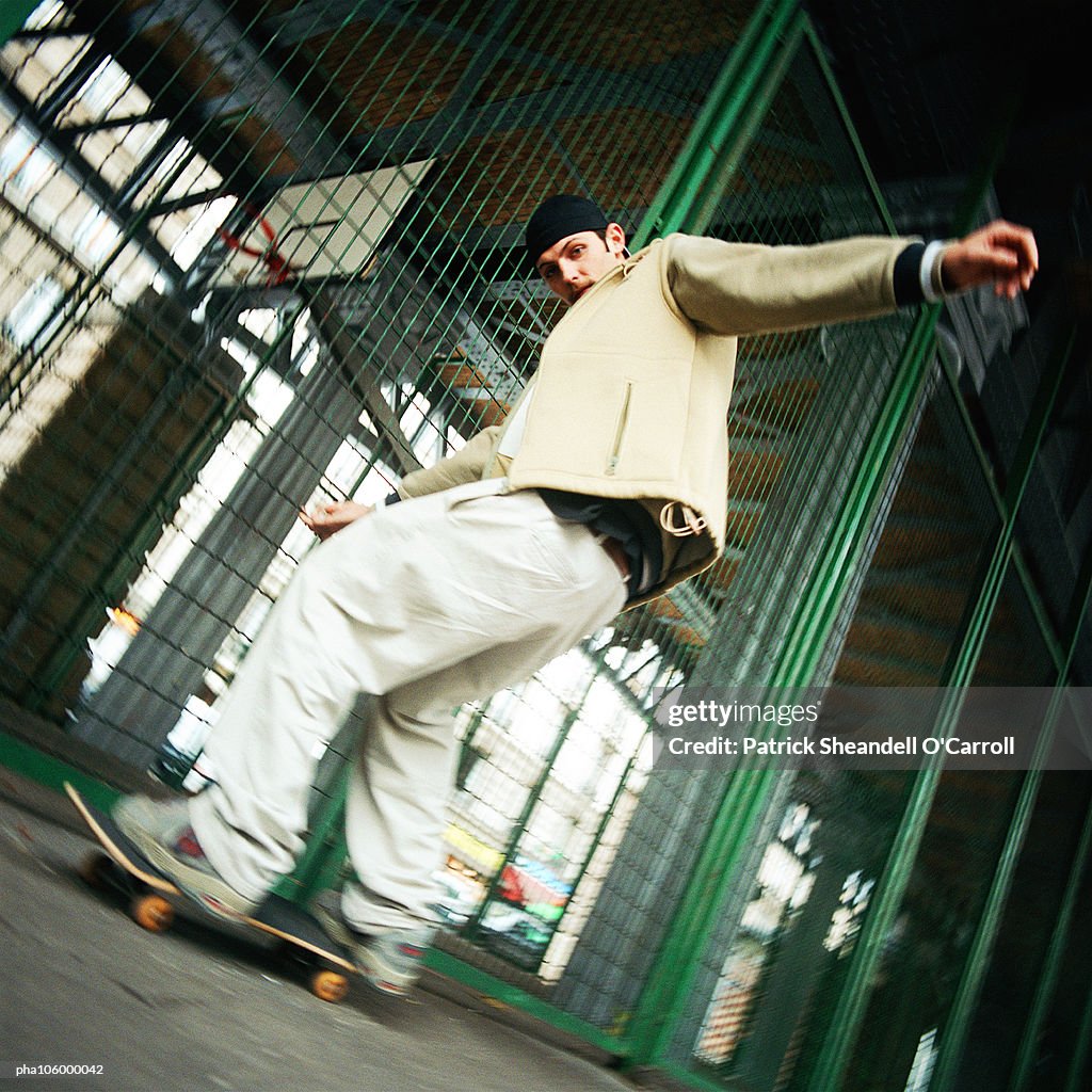 Young man skateboarding, low angle view