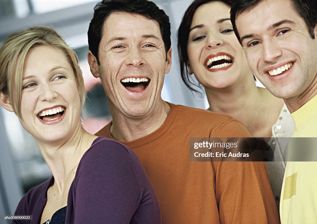 Four people smiling, portrait