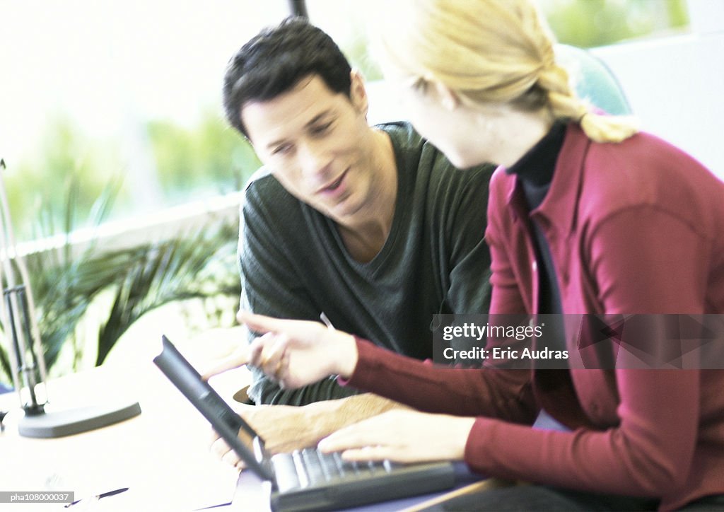 Businessman and woman with laptop computer