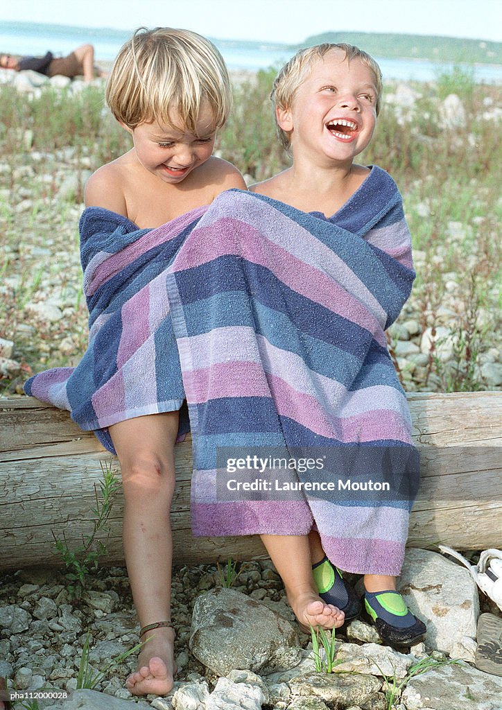 Two boys in bath towel, smiling