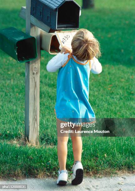 girl looking into mailbox, rear view - examining lawn stock pictures, royalty-free photos & images