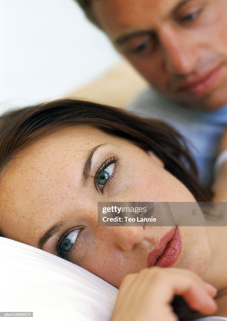 Couple in bed, close-up of woman