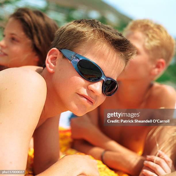 bare-chested teenage boy wearing sunglasses - 15 years girl bare stock pictures, royalty-free photos & images