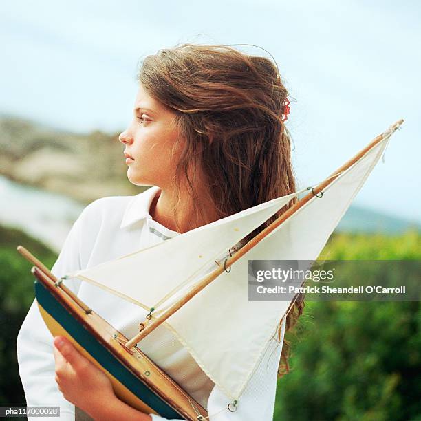 girl holding model boat, outside - modell stock pictures, royalty-free photos & images