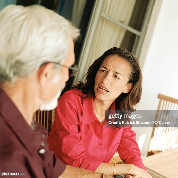 woman speaking with senior man - adults arguing stock pictures, royalty-free photos & images