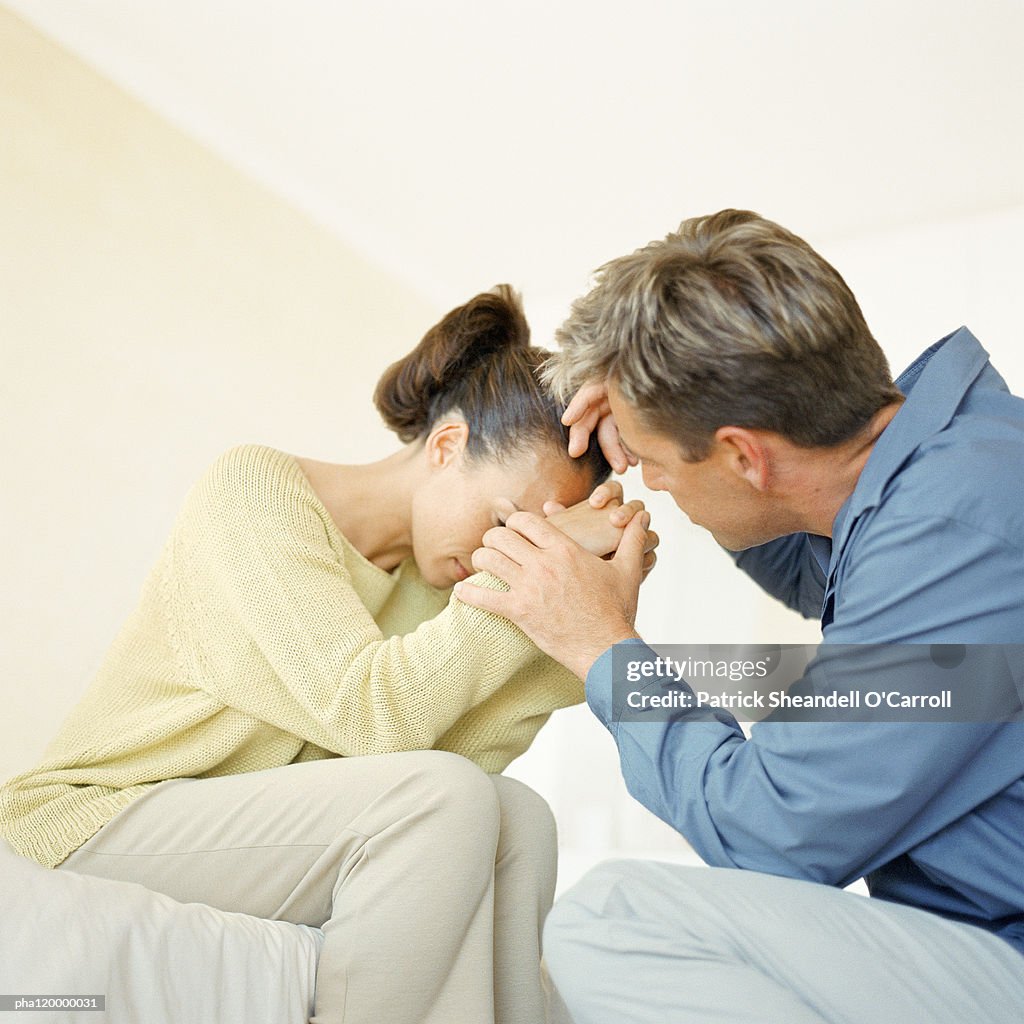 Woman being comforted by man