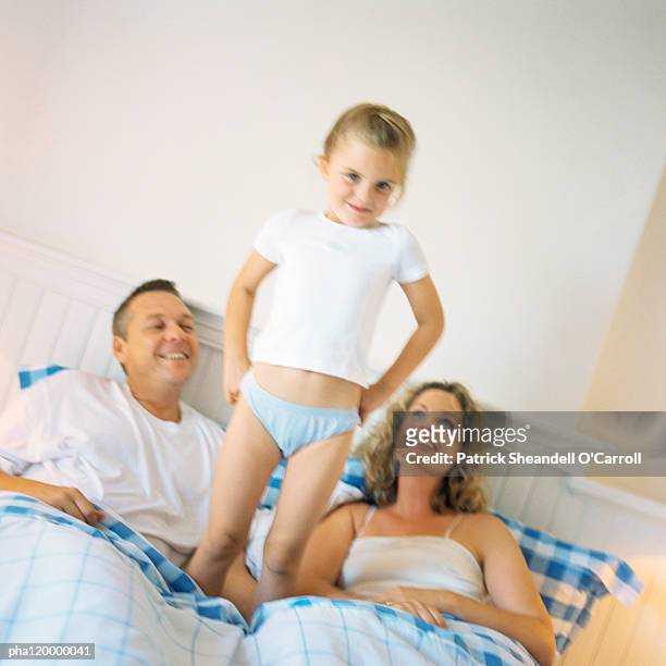 girl standing up on parent's bed - panties girls 個照片及圖片檔