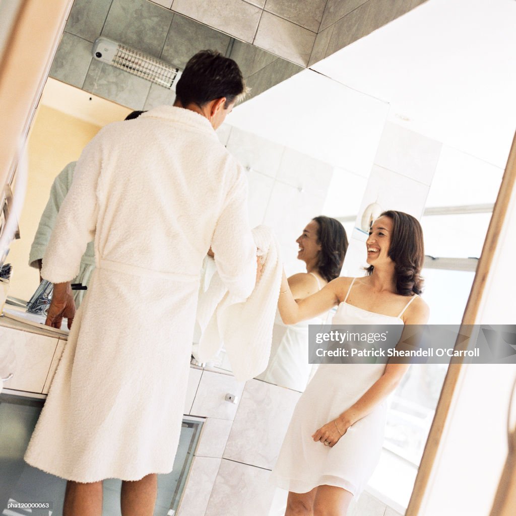 Man and woman standing in bathroom