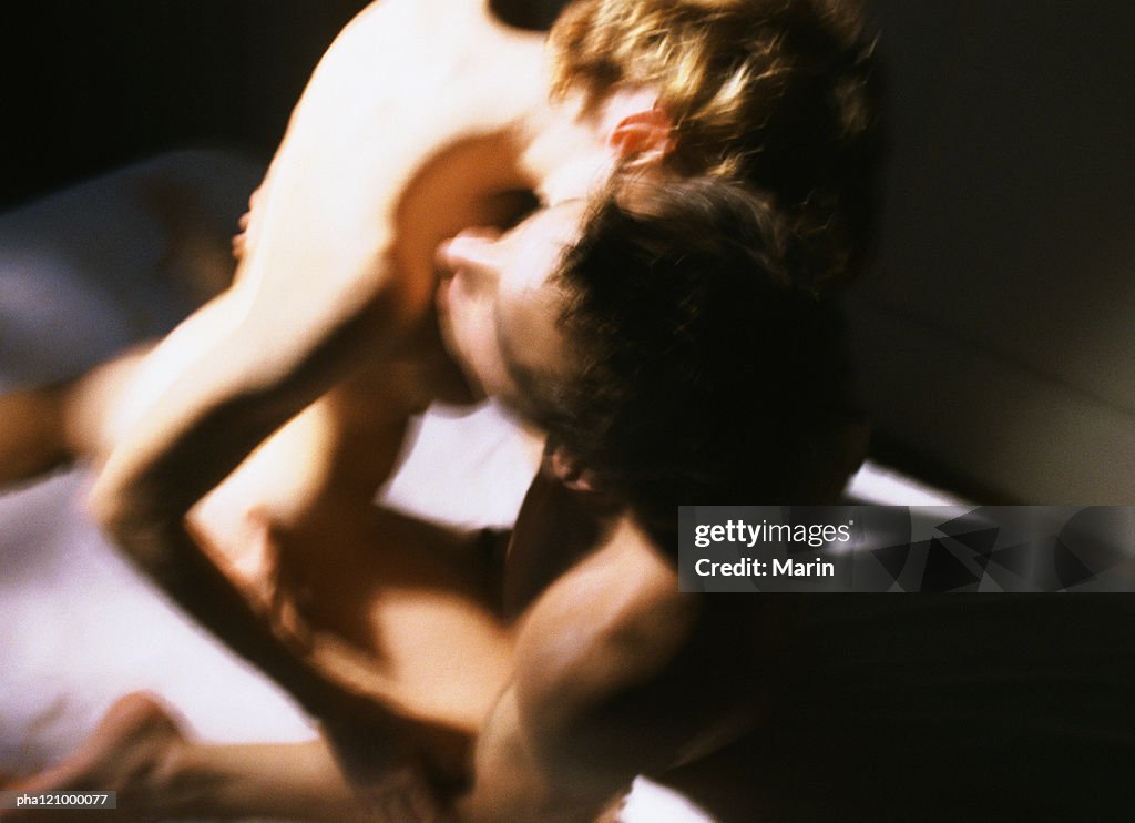 Nude couple embracing, close-up, blurred
