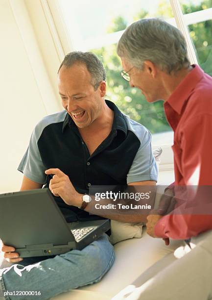 Two Guys Computer Laughing Two People One Computer Photos and Premium High Res Pictures ...