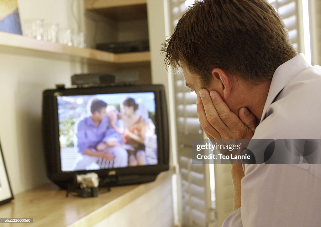 Man watching television, rear view