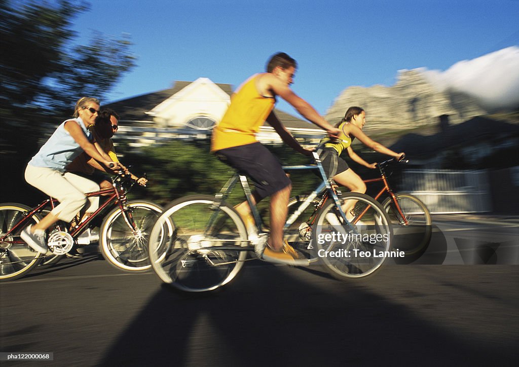 People riding bikes, side view, blurred motion