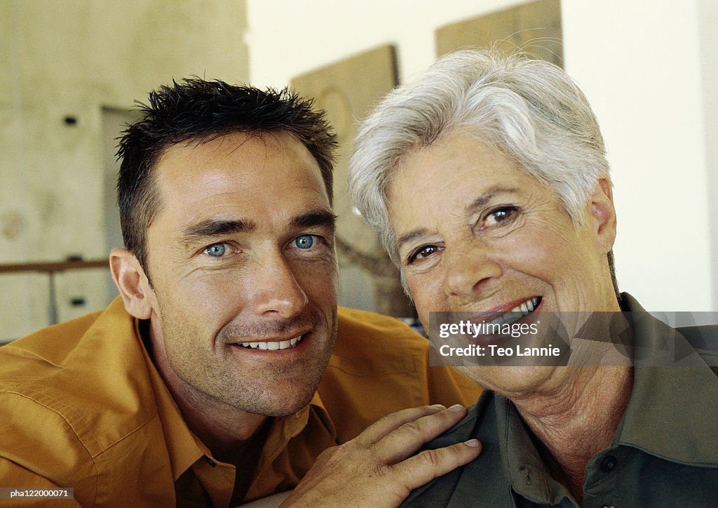 Man and mature woman smiling, portrait