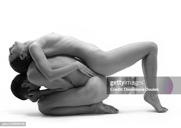 nude man curled in ball with nude woman laying on back, b&w - embarrassed girlfriend stock pictures, royalty-free photos & images