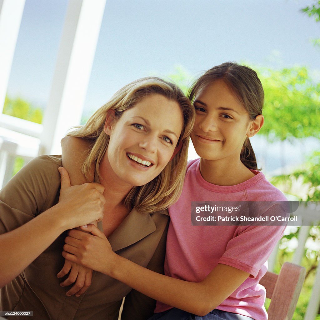 Mother and daughter hugging, portrait