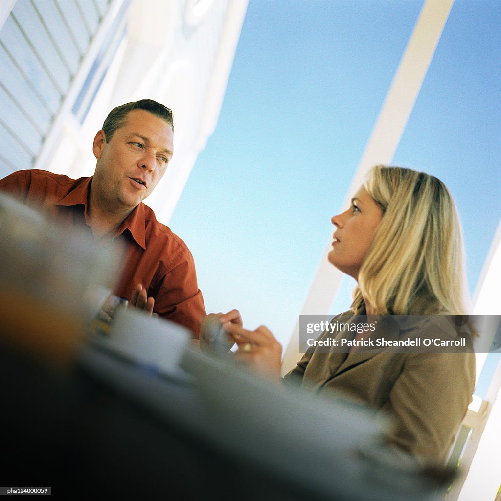 Couple at table, low angle view