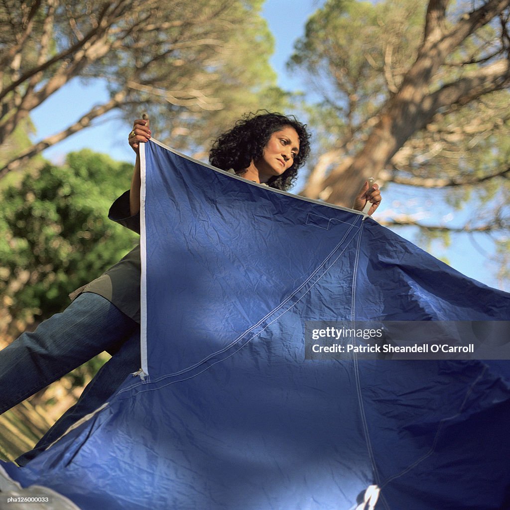 Woman setting up tent