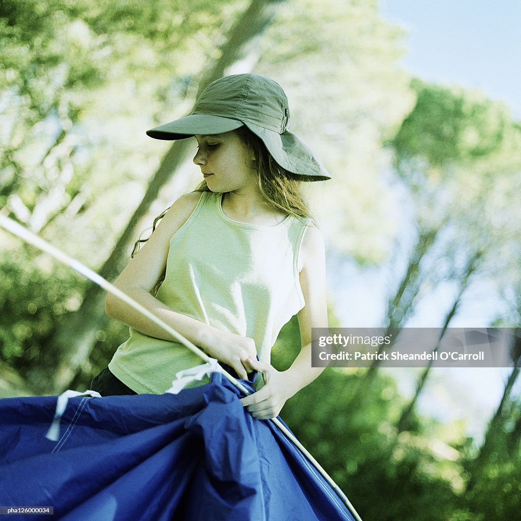 Girl setting up tent