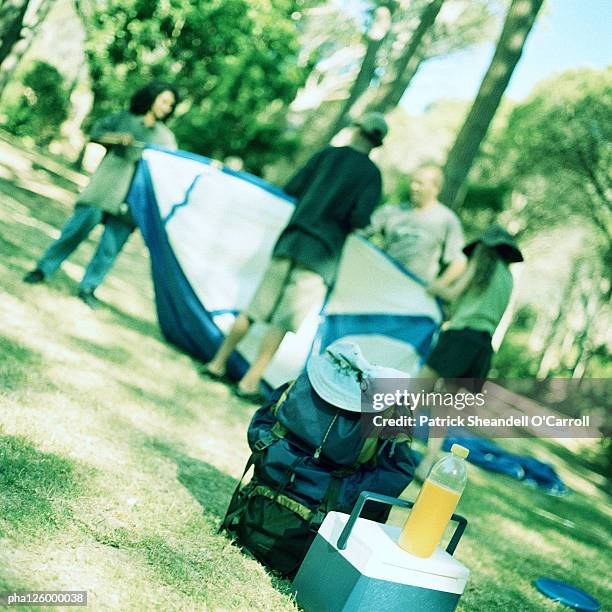 mature couple and children setting up tent - installation of memorial honors victims of ghost ship fire in oakland stockfoto's en -beelden