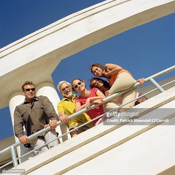 parents, grandfather and children leaning on railing, low angle view - balustrade stock pictures, royalty-free photos & images