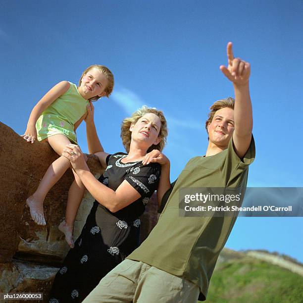 mature woman, girl and teenage boy, outside - being watched stockfoto's en -beelden