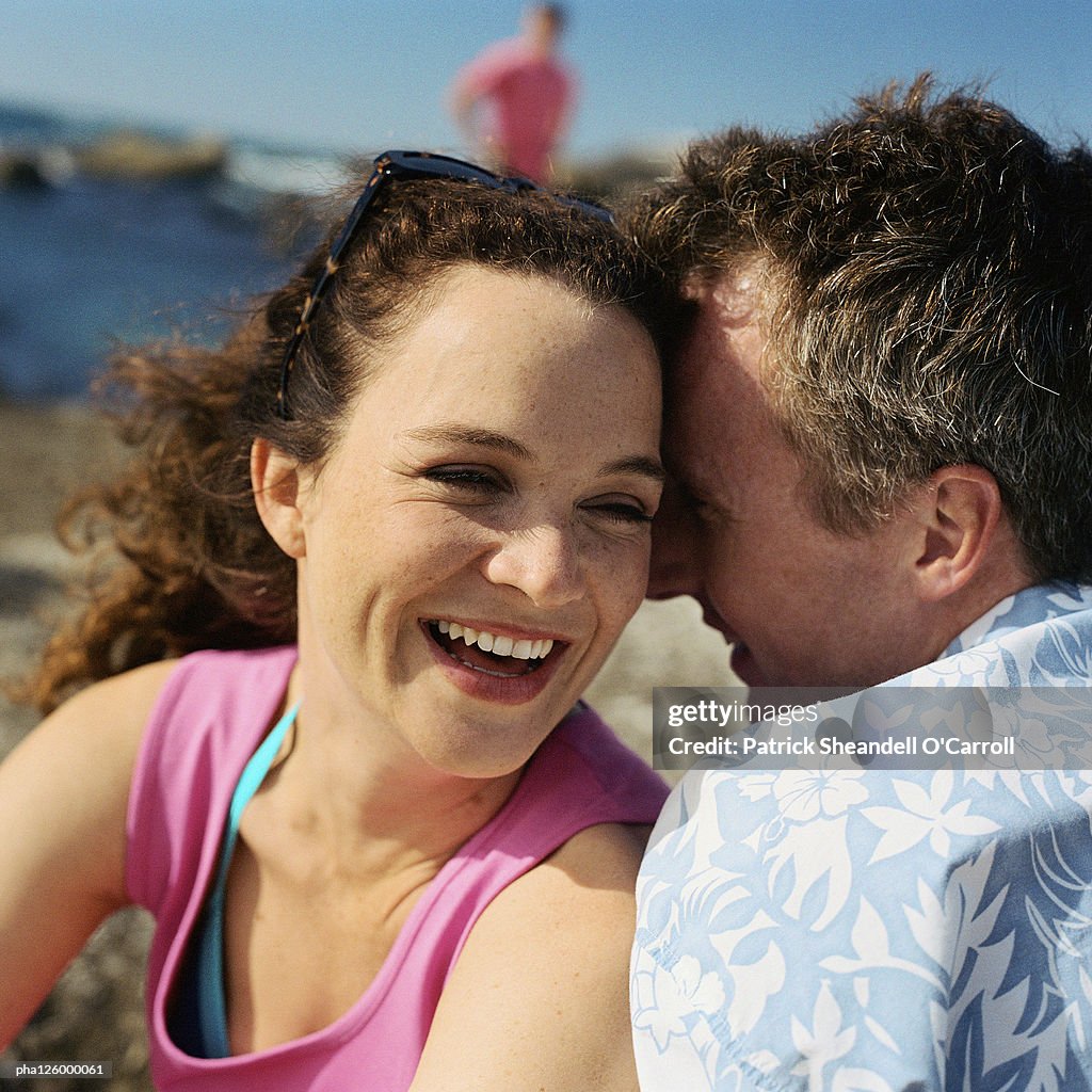 Mature couple hugging on beach, close-up