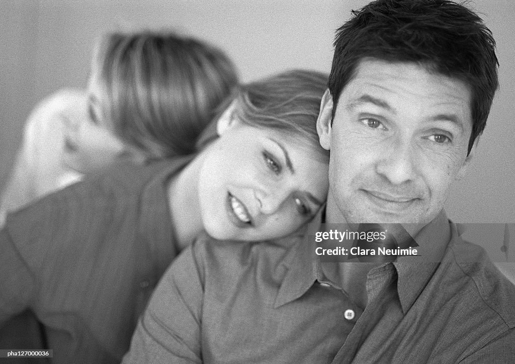 Man and two women leaning on each other, b&w