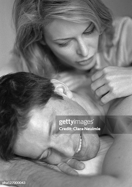 man and woman laying on bed, close-up, b&w - clara stock pictures, royalty-free photos & images