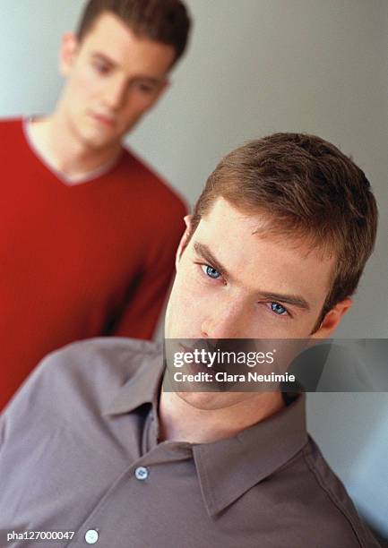 two men, one looking into camera - clara stock pictures, royalty-free photos & images