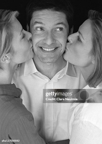 man being kissed by two women, portrait, b&w - clara stock pictures, royalty-free photos & images