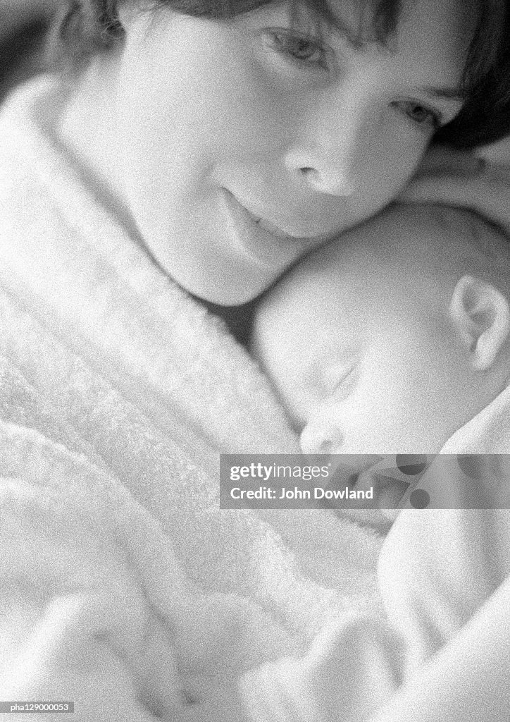 Woman hugging baby, close-up