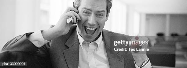 very happy businessman on cell phone, b&w - happy stockfoto's en -beelden