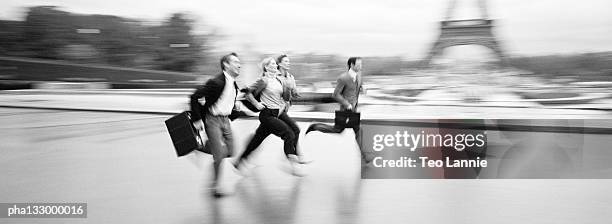 paris, eiffel tower, businessmen and businesswomen running, blurred, b&w - running paris stock-fotos und bilder