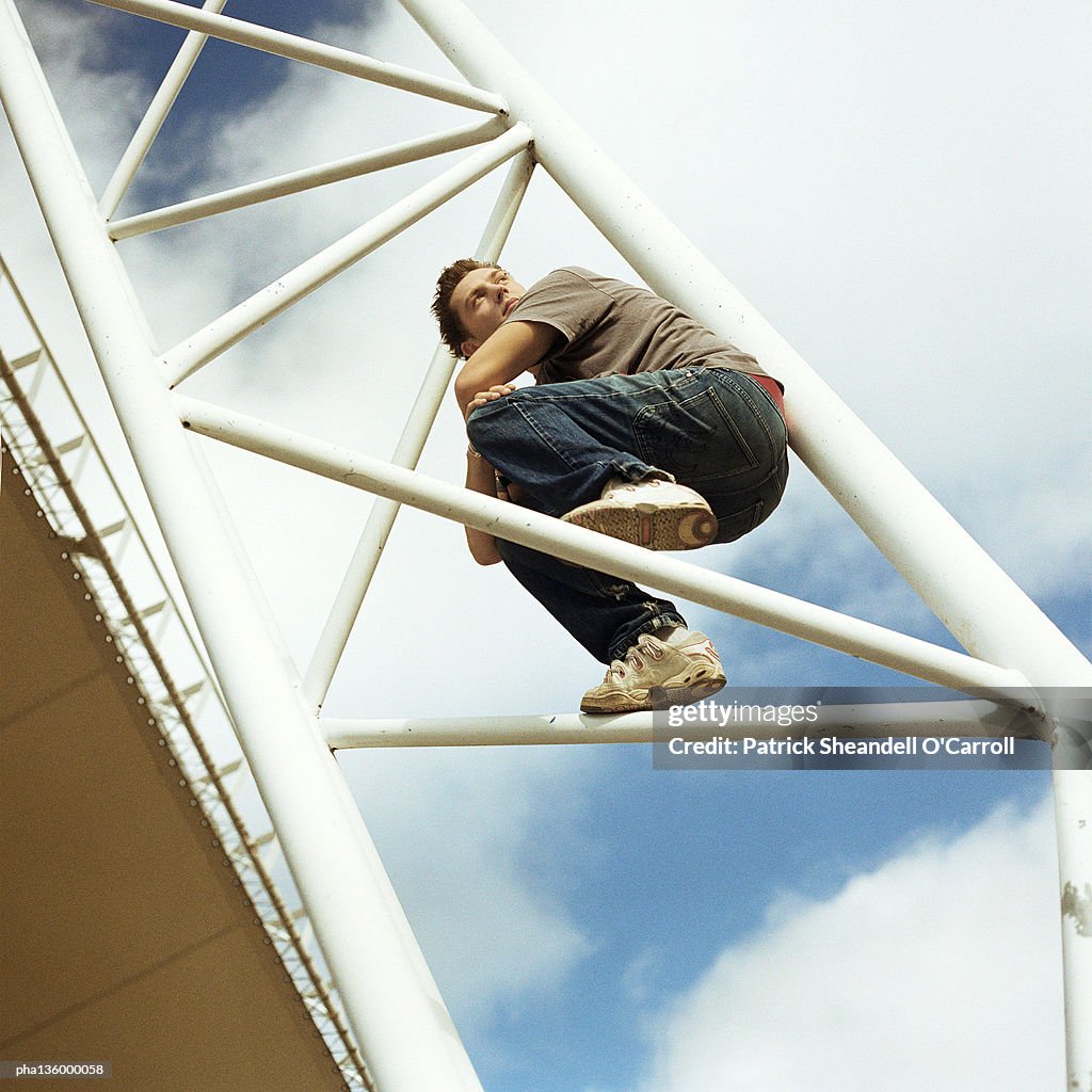 Man crouched on bars