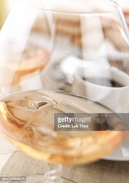 glass of cognac with ice cubes, close-up. - künstliches eis stock-fotos und bilder