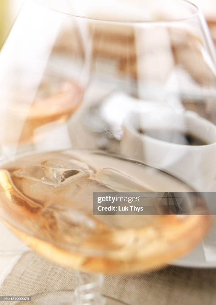 Glass of Cognac with ice cubes, close-up.