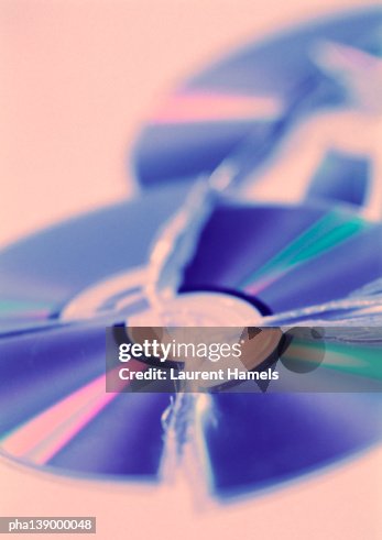 Two broken CD's, blurred. Two broken CD's, blurred.