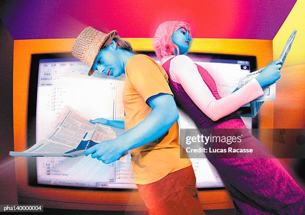 colorful couple standing back to back, reading in front of monitor, digital composite. - classified ad stock pictures, royalty-free photos & images