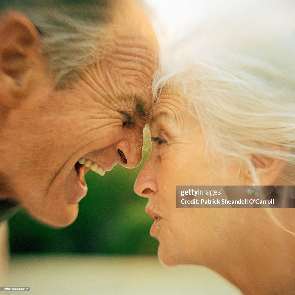 Mature man and woman having argument, side view, close-up